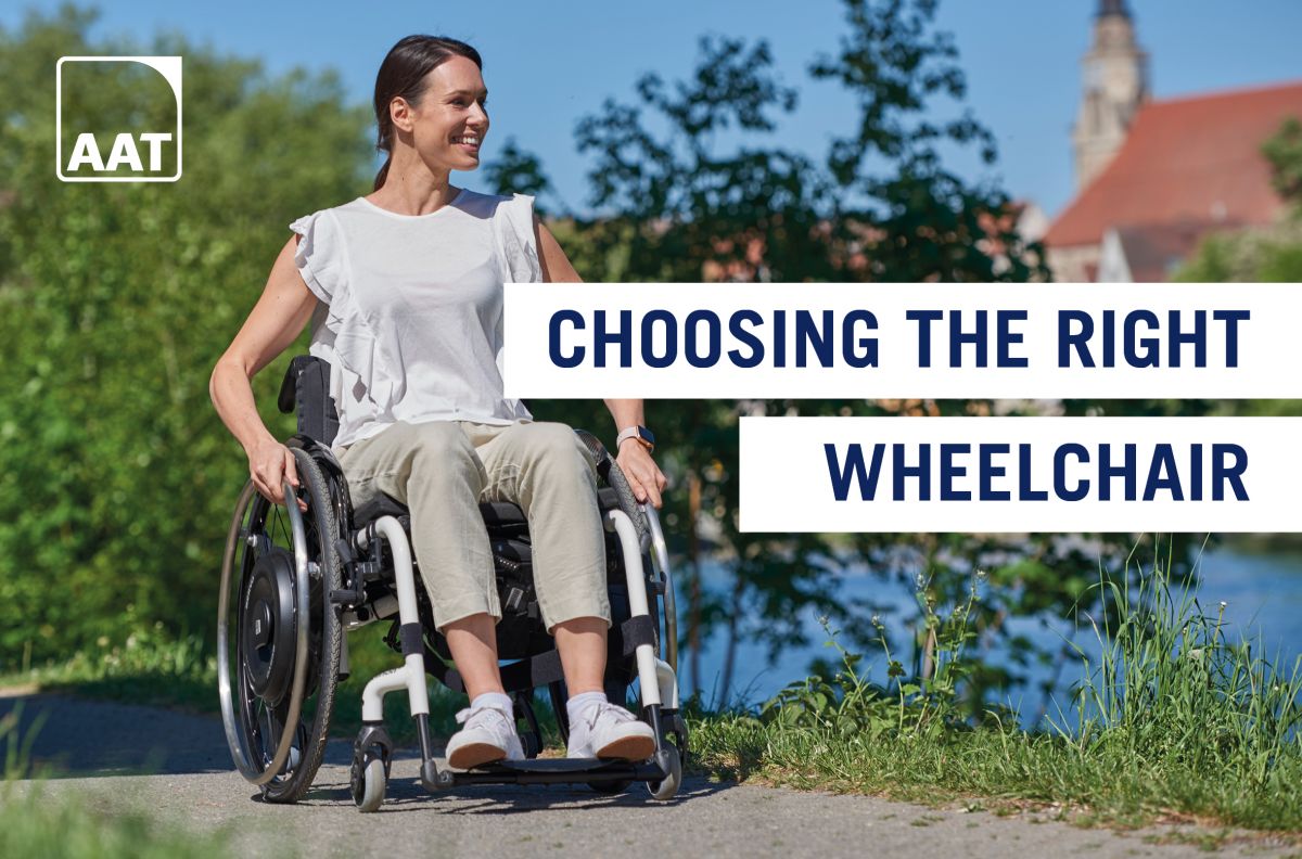 The picture shows an elderly man in a wheelchair being pushed by a young woman. There is a V-MAX mini push aid for wheelchairs on the wheelchair, which is helping the woman to push.